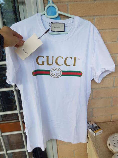 maglia bianca con scritta gucci|T.